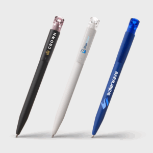 Trois stylos bille colorés sur fond blanc.