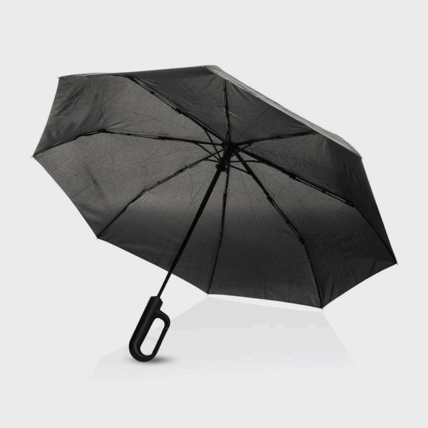 Parapluie noir ouvert sur fond blanc
